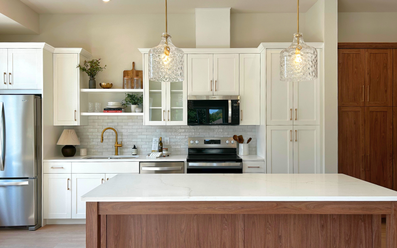 Bright kitchen with large island and stainless steel modern appliances 