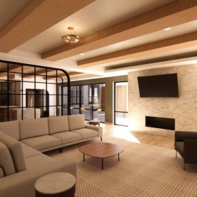 a spacious reservable lounge room with a white couch and large glass wall with abundant natural light and luxury design