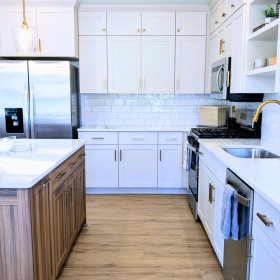a kitchen with white cabinets white countertops and a kitchen island