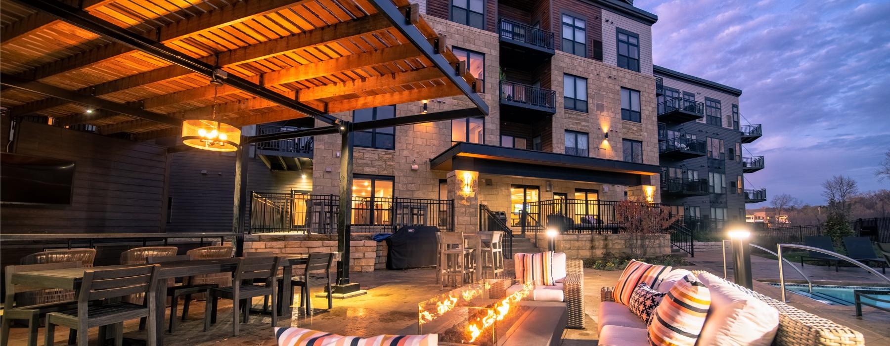 a patio with tables and chairs outside a building