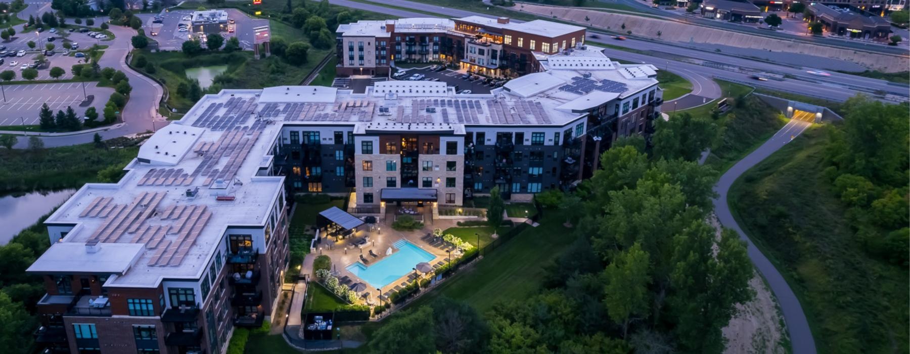 overhead view of a large building with a pool in front of it